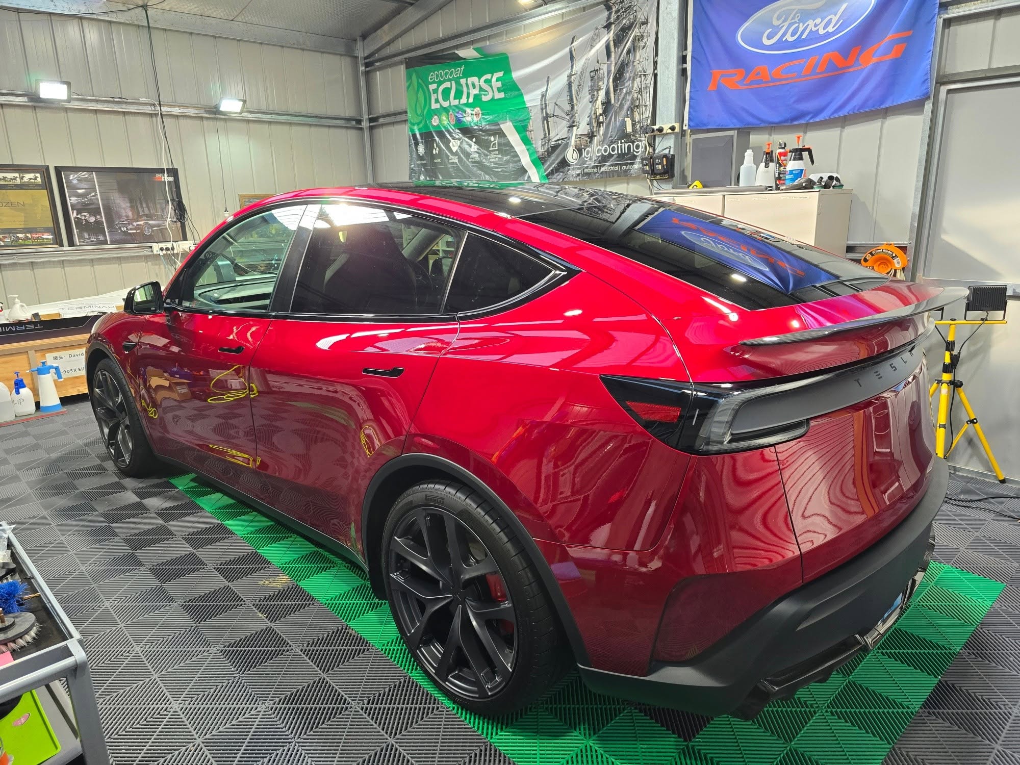 Red Tesla Model Y rear three-quarter, deep candy gloss